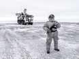 A soldier holds a machine gun as he patrols a Russian military base on Kotelny Island, beyond the Arctic circle in April 2019.
