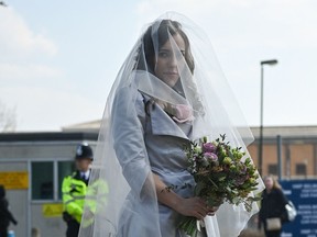 Stella Moris, partner of WikiLeaks founder Julian Assange, poses for photographs in her wedding dress, upon her arrival at the Belmarsh Prison where she is due to marry Julian Assange, on March 23, 2022.