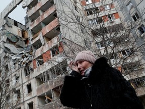 A woman reacts while speaking near a block of flats, which was destroyed during Ukraine-Russia conflict in the besieged southern port city of Mariupol, Ukraine March 17, 2022.