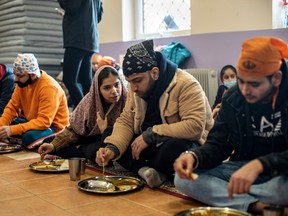 Refugees eat in the community kitchen at a Sikh temple outside of Warsaw.