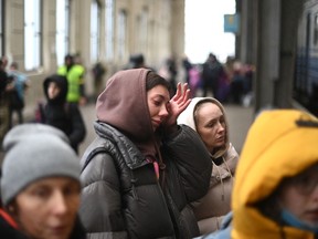 A Ukrainian woman cries as she boards a train taking evacuees to Poland, at the Lviv train station, western Ukraine, on March 5, 2022.