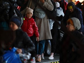 Ukrainische Flüchtlinge warten darauf, die Grenzkontrolle zu passieren, nachdem sie mit einem Zug aus Odessa am Bahnhof Przemysl Glowny angekommen sind, nachdem sie vor der russischen Invasion in der Ukraine geflohen sind, in Przemysl, Polen, am 21. März 2022.