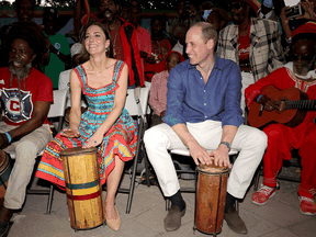 Prince William and Catherine, the Duke and Duchess of Cambridge, play drums during a visit to Trench Town Culture Yard Museum where Bob Marley used to live, during a royal tour of the Caribbean, March 22, 2022 in Kingston, Jamaica.