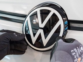 (FILES) In this file photo taken on June 08, 2021 a VW logo is seen at the assembly line for the Volkswagen (VW) ID 3 electric car of German carmaker Volkswagen, at the 'Glassy Manufactory' (Glaeserne Manufaktur) production site in Dresden, eastern Germany.