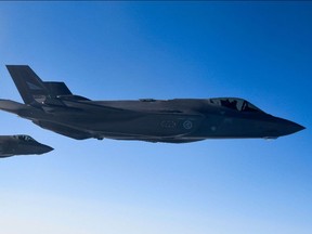 Photograph taken through a window of a NATO refuelling tanker shows Norwegian F-35 fighter jets during NATO exercise 'Cold Response' over Norway on March 22.