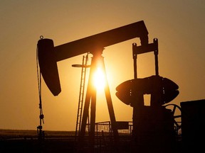 An oil pump jack pumps oil in a field near Calgary, Alberta, Canada on July 21, 2014.