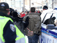 Police make an arrest at the Freedom Convoy protest in Ottawa, February 18, 2022.