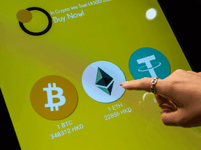 The logos of Bitcoin, Ethereum and Tether are seen on a cryptocurrency automated teller machine in Hong Kong.