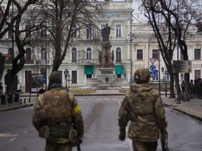 Members of Ukraine's Territorial Defence Forces patrol a street, amid the Russian invasion of Ukraine, in Odessa, Ukraine, in this handout picture released March 4, 2022.
