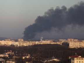Smoke rises above buildings near Lviv airport, as Russia's invasion of Ukraine continues, in Lviv.