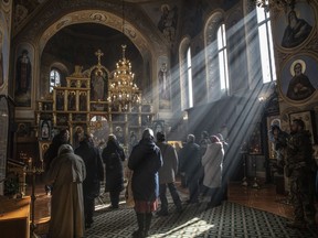 Ukrainian Orthodox Christians attend Sunday church services at the Monastery of St. Theodosius in Kyiv.