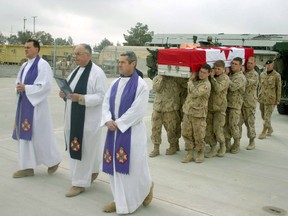 Three Canadian Forces chaplains lead the pallbearer party, as a soldier's body is sent home from Afghanistan in 2006.