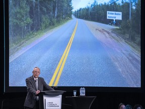 Commission counsel Roger Burrill displays a photo that shows the stretch of Plains Road where Heather O'Brien and Kristen Beaton were murdered by Gabriel Wortman, at the Mass Casualty Commission inquiry in Halifax on March 31, 2022.