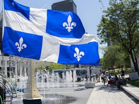 A Quebec flag flaps in the wind at a walk through installation to celebrate Saint-Jean-Baptiste Day in Montreal on Thursday, June 24, 2021. THE CANADIAN PRESS/Graham Hughes