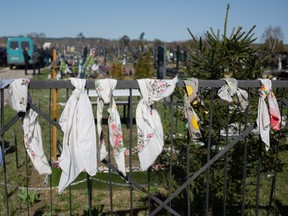 Funeral scarfs hang on the cemetery fence on April 14, 2022 in Hostomel, Ukraine.