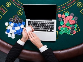 casino, online gambling, technology and people concept - close up