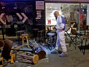 Forensics experts investigate the scene of a shooting attack on Dizengoff Street in Tel Aviv, on April 7.