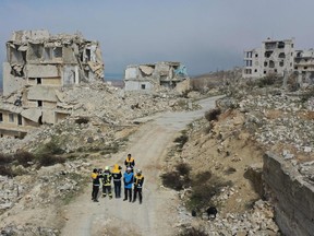 Members of the White Helmets film an instructive video intended for Ukrainian rescuers, in the war-ravaged Syrian town of Ariha in the rebel-held northwestern Idlib province, on March 16, 2022.