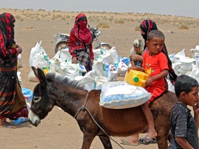 Poor Yemeni families receive flour rations and other basic food supplies on March 29. The cost of delivering food to the world's most needy people has increased by around 30 per cent since 2019, writes Heather Exner-Pirot.