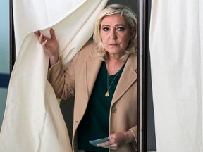 French far-right party Rassemblement National (RN) presidential candidate Marine Le Pen leaves the polling booth as she votes during the first round of France's presidential election at a polling station in Henin-Beaumont, northern France on April 10, 2022.