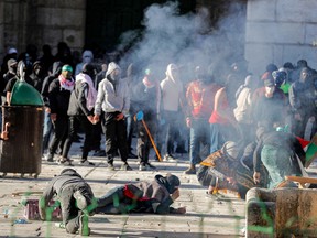 Palestinian demonstrators clash with Israeli police at Jerusalem's Al-Aqsa mosque compound on April 15.