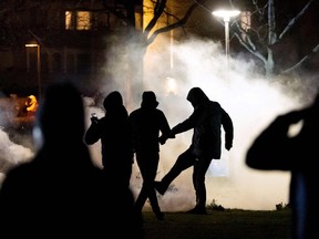A protester kicks a tear gas canister in Malmo on April 17, 2022.