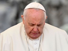 Pope Francis grimaces as he gets up on April 20, 2022 during the weekly general audience at St. Peter's square in The Vatican. (Photo by Alberto PIZZOLI / AFP) (Photo by ALBERTO PIZZOLI/AFP via Getty Images)