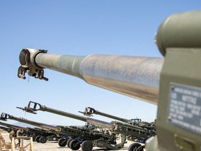 US Marines Corps' M777 155 mm howitzers are staged on the flight line prior to being loaded on to a US Air Force C-17 Globemaster III aircraft at March Air Reserve Base, California, April 22, 2022.