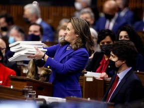 Canada's Finance Minister Chrystia Freeland holds the 2022-23 budget next to Prime Minister Justin Trudeau, in the House of Commons on Parliament Hill in Ottawa, Ontario, Canada, April 7, 2022. REUTERS/Blair Gable