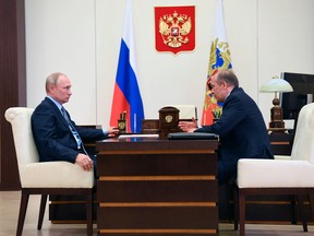 Russian President Vladimir Putin, left, listens to Federal Security Service (FSB) Director Alexander Bortnikov during a meeting in 2020.