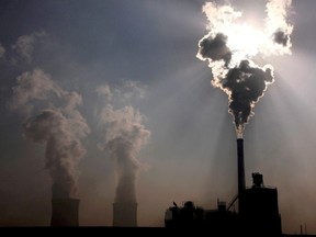 A coal-burning power plant can be seen behind a factory in China's Inner Mongolia Autonomous Region, October 31, 2010.