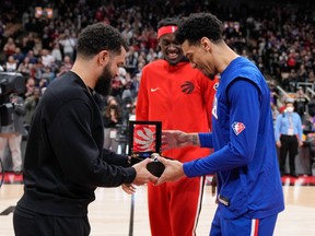 Danny Green #14 of the Philadelphia 76ers is presented his 2018-2019 Championship ring from when he played on the Toronto Raptors by Fred VanVleet  #23 and Pascal Siakam #43 before their basketball game at the Scotiabank Arena on April 7, 2022 in Toronto.