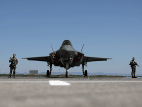 Dutch soldiers stand guard near a Royal Netherlands Air Force F-35 at Graf Ignatievo airbase, Bulgaria, April 14, 2022.