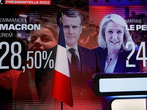 Election results with the two candidates for the second round in the 2022 French presidential election, French President Emmanuel Macron, candidate for his re-election, and Marine Le Pen, leader of French far-right National Rally (Rassemblement National) party, are seen on a screen at the Marine Le Pen's venue, in Paris, France April 10, 2022.
