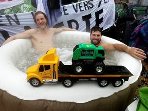 Two Freedom Convoy protesters sit in a hot tub in downtown Ottawa on Feb. 17, 2022.