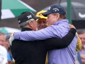 South Africa’s Gary Player, Jack Nicklaus of the U.S. and Tom Watson of the U.S. embrace on the 1st tee during the ceremonial start on the first day of play.
