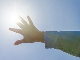 Woman's hand and the Sun.