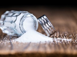 Old wooden table with a Salt Shaker (close-up shot; selective focus)