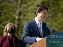 Prime Minister Justin Trudeau, with Merran Smith of Clean Energy Canada, speaks to reporters at Royal Roads University in Victoria, B.C., April 11, 2022.