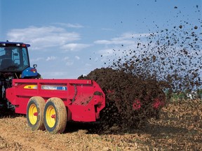A New Holland Agriculture 100 series box spreader distributes solid manure on a farm field in Rising Sun, Maryland, U.S., in this undated handout photo.