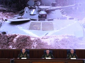 Mikhail Mizintsev (R), head of the Russian National Defence Control Centre, joins two other senior defence officials to hold a briefing on Russian military action in Ukraine, in Moscow on March 25, 2022.