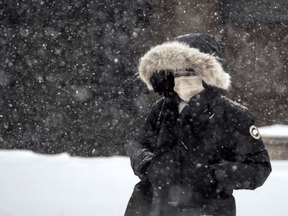A pedestrian walks through a snowstorm in Toronto in January 2022.