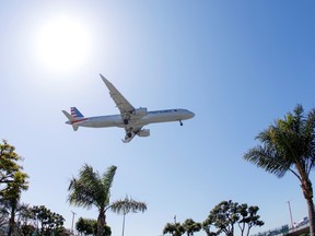 An American Airlines passenger jet approaches to land at LAX during the outbreak of the coronavirus disease (COVID-19) in Los Angeles, California, U.S., April 7, 2021. REUTERS/Mike Blake/File Photo