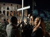 A Ukrainian and a Russian women carry a cross together during the Good Friday procession at the Colosseum in Rome, April 15, 2022.