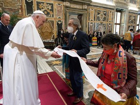 Pope Francis receives a stole from Phil Fontaine, former national chief of the Assembly of First Nations, during a papal audience with Canada's Indigenous delegation at the Vatican on April 1, 2022. The Pope apologized for the conduct of some members of the Catholic Church at residential schools.