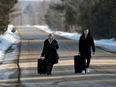 Asylum seekers cross into Canada from the U.S. border near a checkpoint on Roxham Road near Hemmingford, Quebec, Canada April 24, 2022.