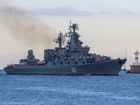 The Russian Navy's guided missile cruiser Moskva sails back into a harbour after tracking NATO warships in the Black Sea, in the port of Sevastopol, Crimea November 16, 2021.