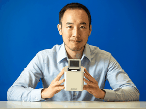 Spartan Bioscience Inc. CEO Paul Lem holds a Spartan Cube, a portable, rapid COVID testing device the company developed.