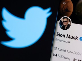 Elon Musk's twitter account is seen on a smartphone in front of the Twitter logo in this photo illustration taken, April 15, 2022.