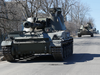 Pro-Russian troops are seen atop armoured vehicles in Dokuchaievsk in the Donetsk region, Ukraine March 28, 2022.